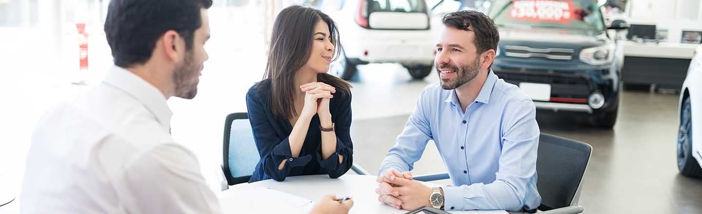 image of 2 people at a table talking with a salesman