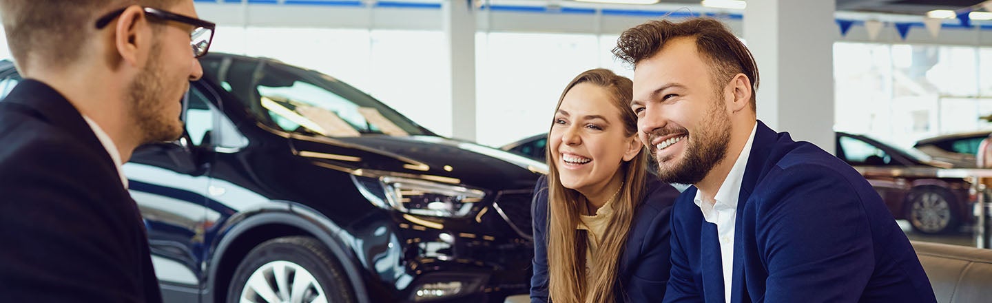 image of a man and woman working with a salesman