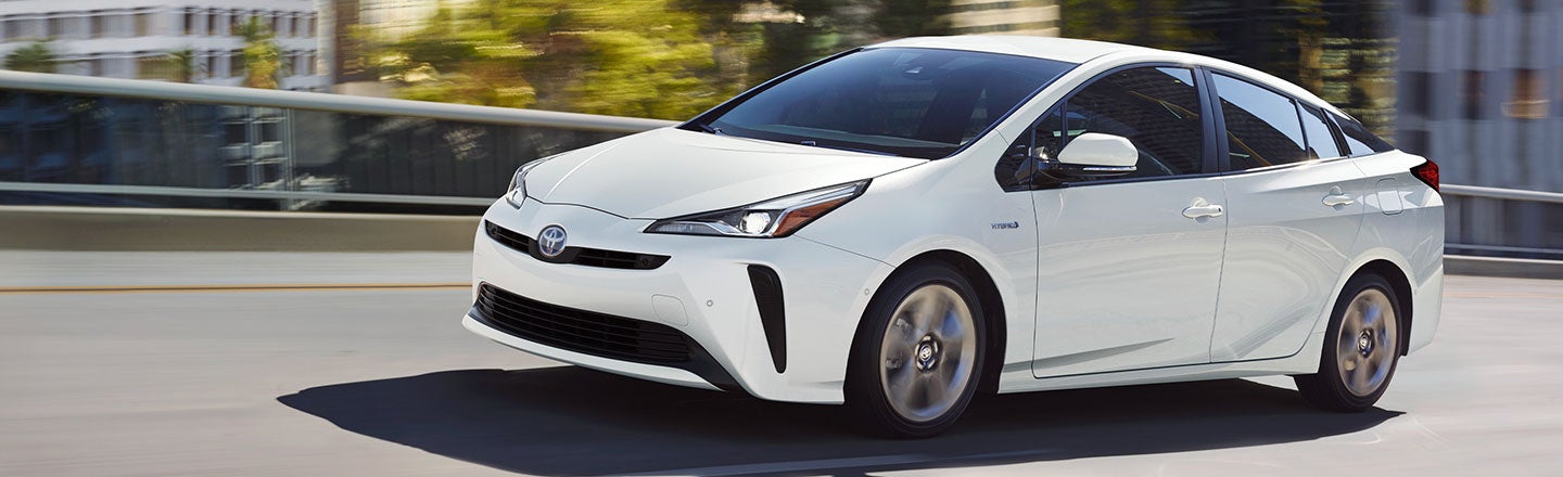 image a white Toyota hatchback driving